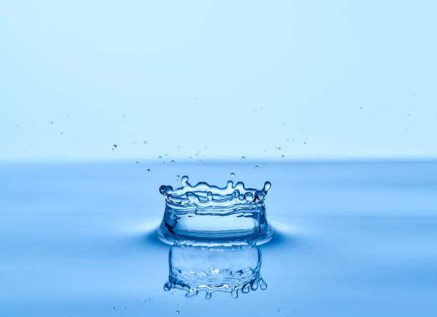 istock Group of water droplets fall and bounce on a water surface 1700266643