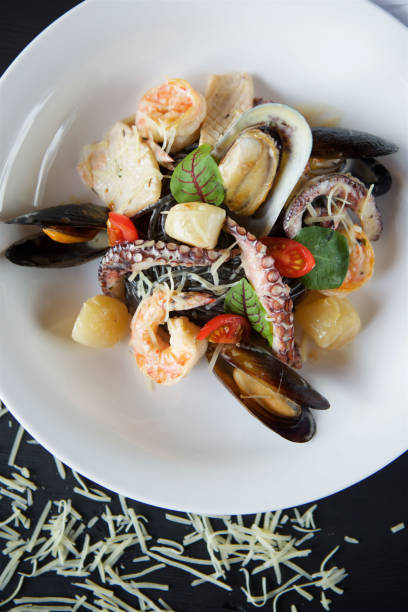 istock Shrimp clams and octopuses served with cheese and basil 1700268293