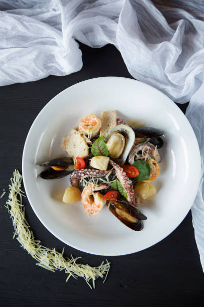 istock Shrimp clams and octopuses served with cheese and basil 1700268815