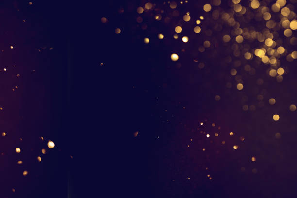 istock Golden abstract bokeh on black background. 1700271104