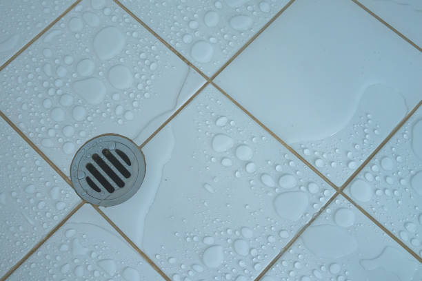 istock Water flowing over into metal drain 1700271654