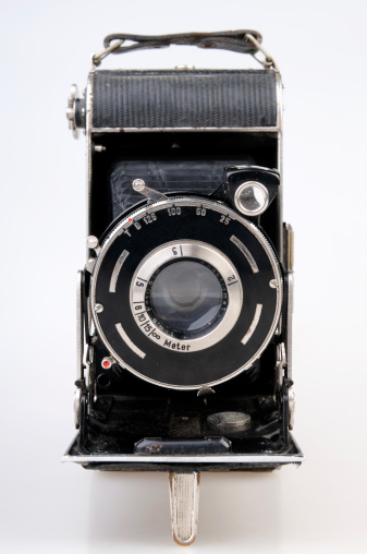 old analog slr camera seen from the side - on white background