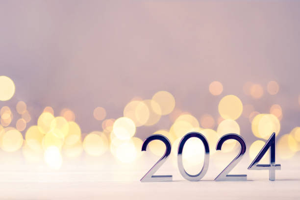 istock Metal numbers 2024 on table with bokeh lights. 1700277231