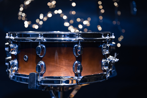 Close-up, snare drum on a blurred background with bokeh lights, winter holiday concept.