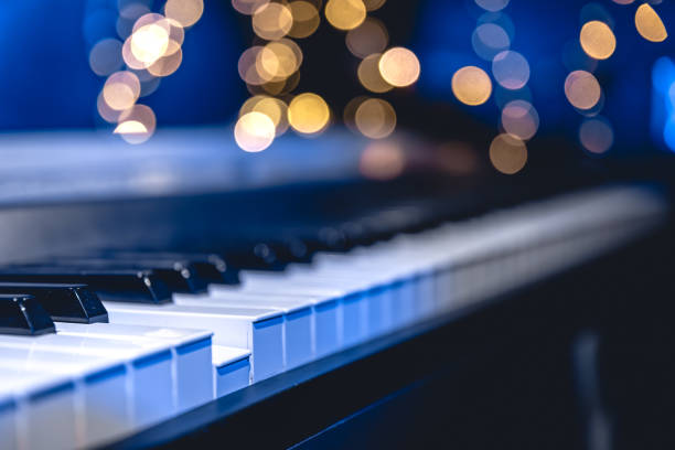 istock Piano keys close-up on a blurred background with bokeh. 1700281674