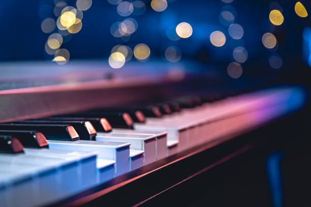 istock Piano keys close-up on a blurred background with bokeh. 1700281675