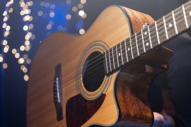 istock Close-up, acoustic guitar on a dark background with bokeh lights. 1700281677
