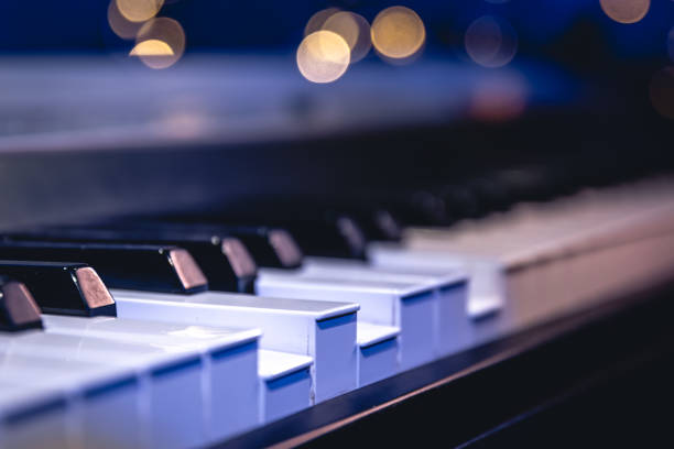 istock Piano keys close-up on a blurred background with bokeh. 1700281678