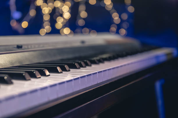 istock Piano keys close-up on a blurred background with bokeh. 1700281685