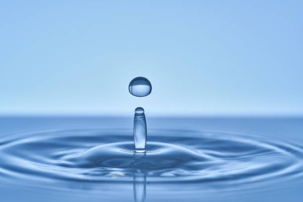 istock Group of water droplets fall and bounce on a water surface 1700281711