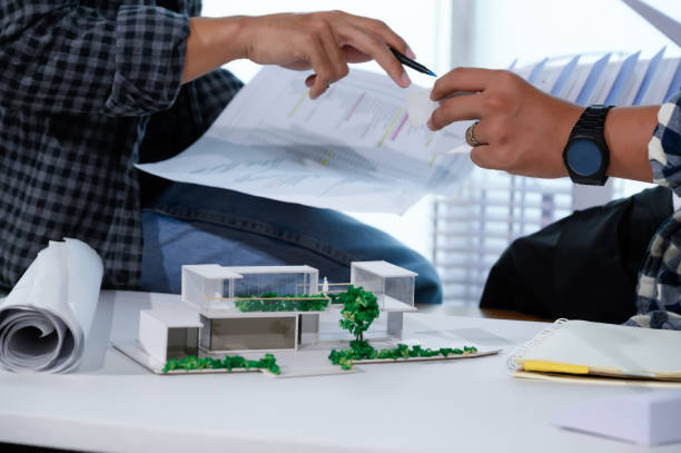 istock Asian Architect Students Studying Modern House Design and Finding Ways to Utilize Natural Alternative Energy or Use Natural Renewable Energy, Concepts of Eco-Friendly Living for a Sustainable Future. 1700285529