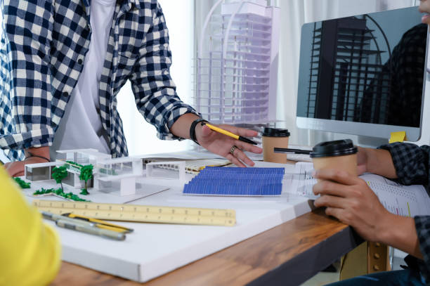istock Asian Architect Students Studying Modern House Design and Finding Ways to Utilize Natural Alternative Energy or Use Natural Renewable Energy, Concepts of Eco-Friendly Living for a Sustainable Future. 1700285531