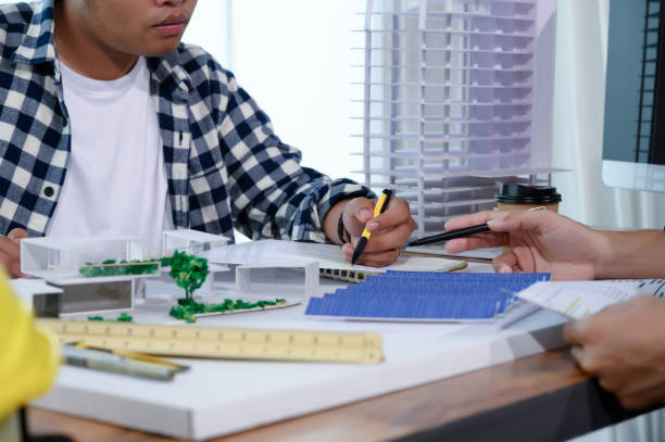 istock Asian Architect Students Studying Modern House Design and Finding Ways to Utilize Natural Alternative Energy or Use Natural Renewable Energy, Concepts of Eco-Friendly Living for a Sustainable Future. 1700285538