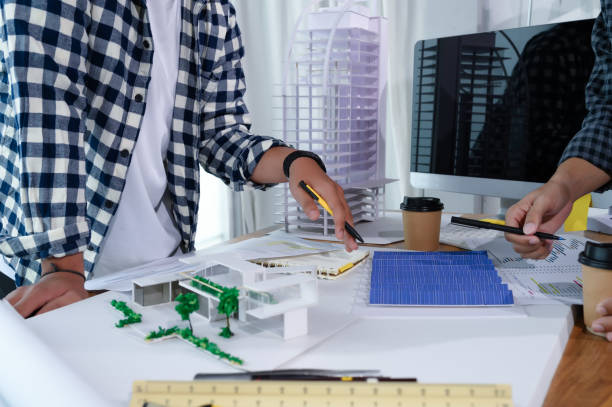 istock Asian Architect Students Studying Modern House Design and Finding Ways to Utilize Natural Alternative Energy or Use Natural Renewable Energy, Concepts of Eco-Friendly Living for a Sustainable Future. 1700285542