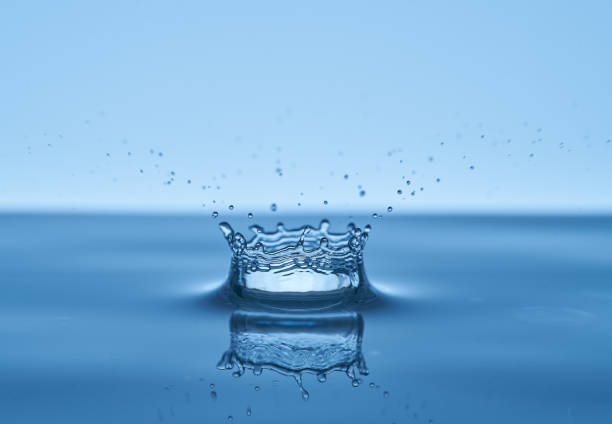 Clear aqua water droplet splashing in concentric circles, capturing refreshing purity.