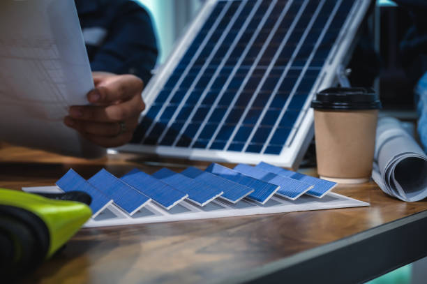 istock Close-up Solar Farm Sample Model on Desks Office Engineers While Meeting and Discussions. 1700287774