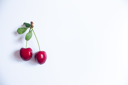 Cherries on a white background. Top view, copy space.