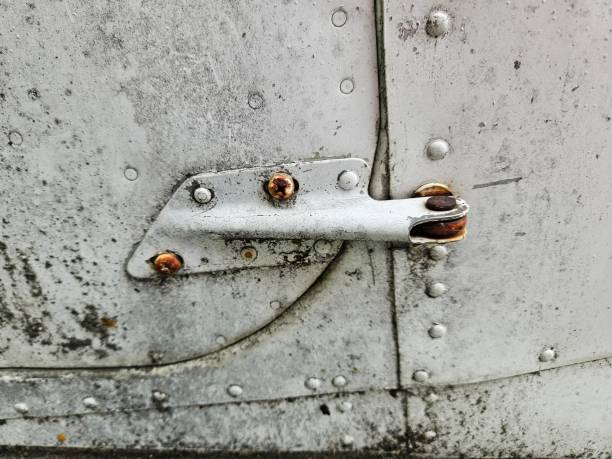 istock Rusty metal door hinge on a small airplane. 1700289412