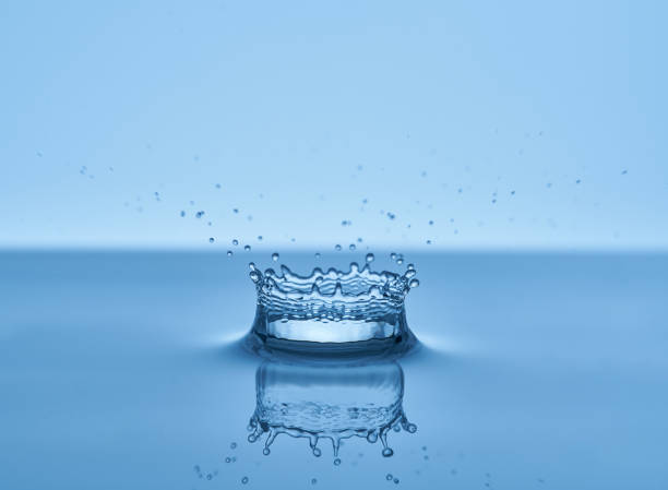 istock Group of water droplets fall and bounce on a water surface 1700289416