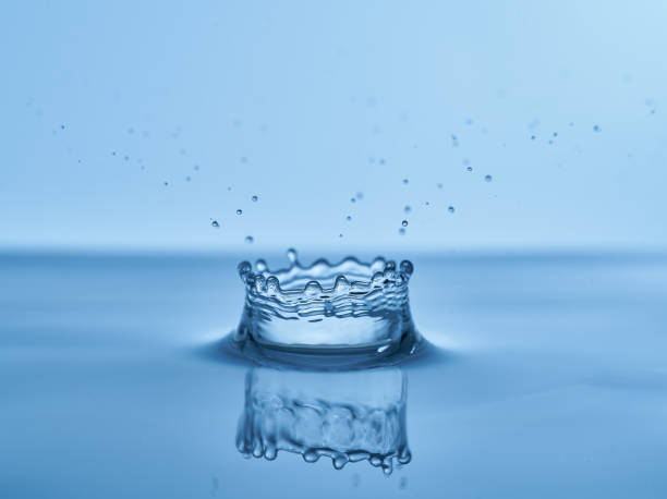 istock Group of water droplets fall and bounce on a water surface 1700290004