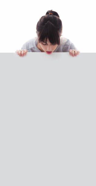 istock woman holding a white board with copy space 170029265