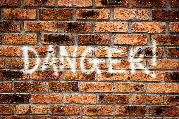 istock DANGER! reads warning graffiti on grungy brick urban wall 170029893