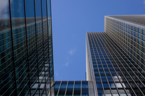 Generic all glass office building set against blue sky on nice day