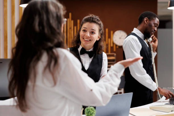 istock Concierge assists with check-in at hotel 1700305977