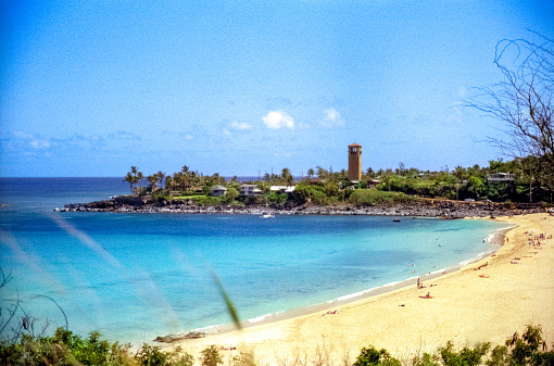 Vintage 1970s film photograph of big rock beach at Waimea Bay, on the tropical island of Kauai, Hawaii.
