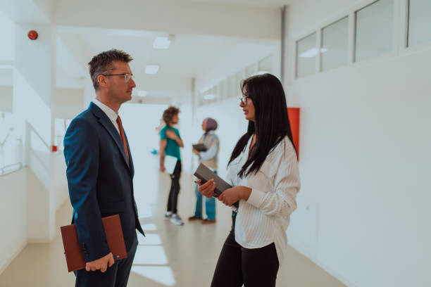 istock Business colleagues engage in a knowledge-sharing conversation during a coffee break in a modern corporate environment, exemplifying professional collaboration and skill enhancement within a bustling business corporation 1700315317