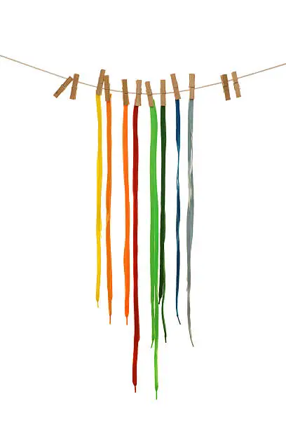 coloured shoelaces hanging on the clothesline. Image isolated on white background