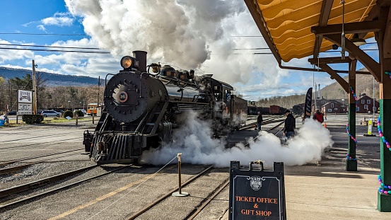 Rockhill Furnace, United States – April 01, 2023: A View of a Restored Narrow Gauge Steam Locomotive Blowing Smoke and Steam on a Winters Day