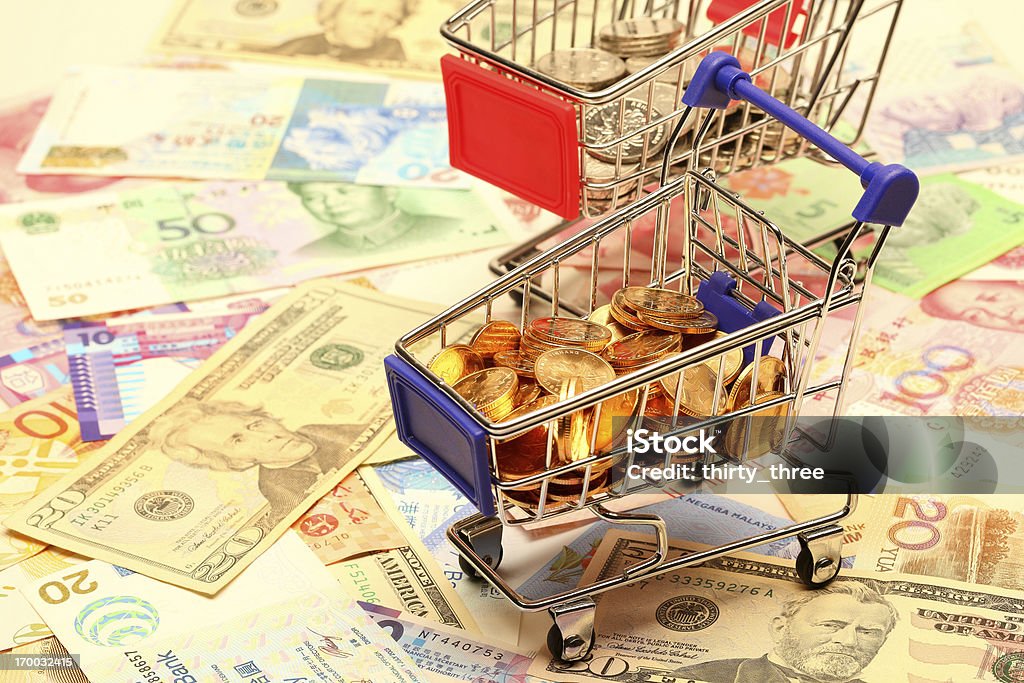Currencies Coins in the mini shopping cart on the currencies Hong Kong Dollars Stock Photo