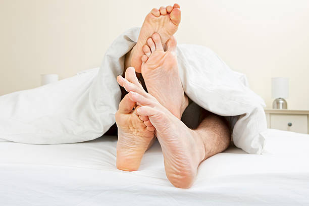 молодая пара messing в постель - sole of foot human foot women humor стоковые фото и изображения