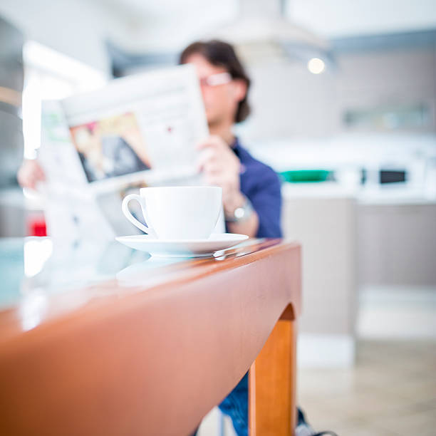 istock Relaxed man sitting with coffee and a newspaper 170032667