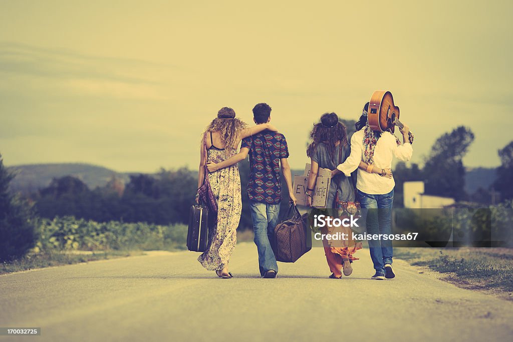 Group of hippie friends walk away Group of hippie friends walk away. Vintage style Hippie Stock Photo