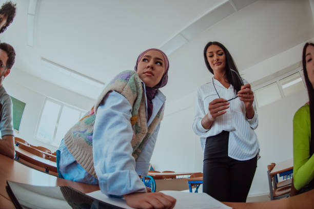 istock A diverse group of students gathers in a modern school classroom, passionately engaging in lively discussions about various projects, embracing teamwork and utilizing technology to enhance their learning experience 1700328089
