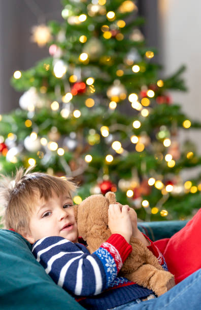 istock Child at Christmas hugging a teddy bear 1700335362