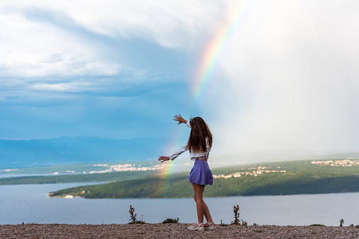 Catching the Rainbow - Teenage Girl on Seaside Holiday on the Top of the Hill After Rain Trying to Catch the Rainbow
