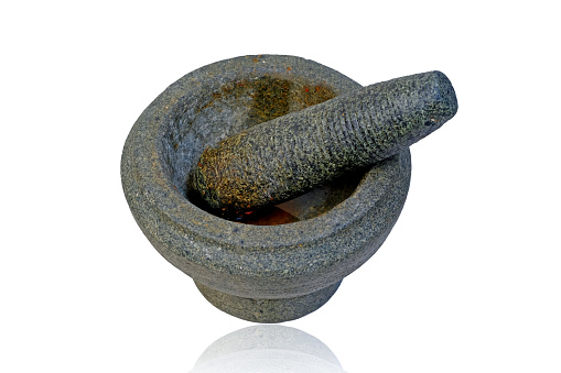 Mortar and pestle isolated on a white background with reflection