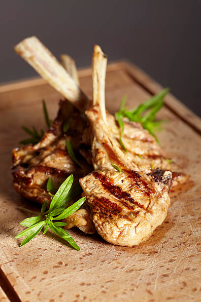 Appetizing grilled cutlets on a wooden cutting board.