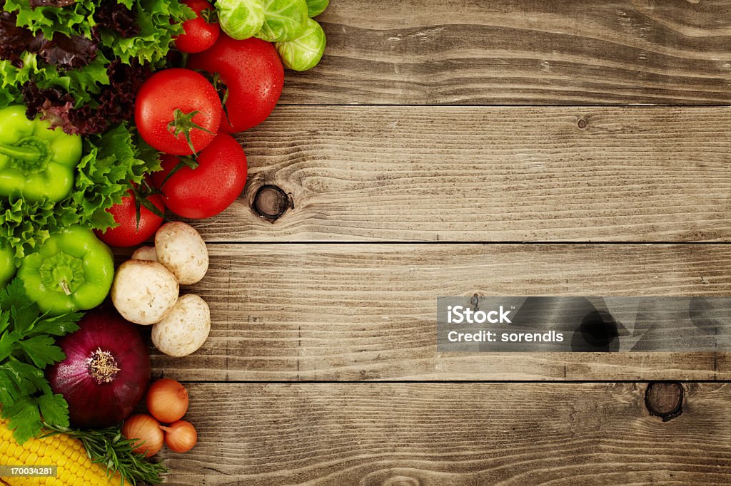 Healthy Organic Vegetables on a Wooden Background Directly above view of raw vegetables on wooden table Vegetable Stock Photo