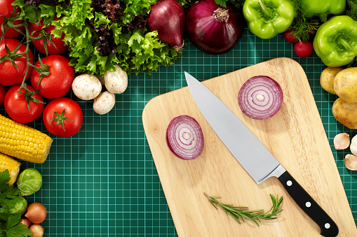 Directly above view of vegetables, cutting board and a knife