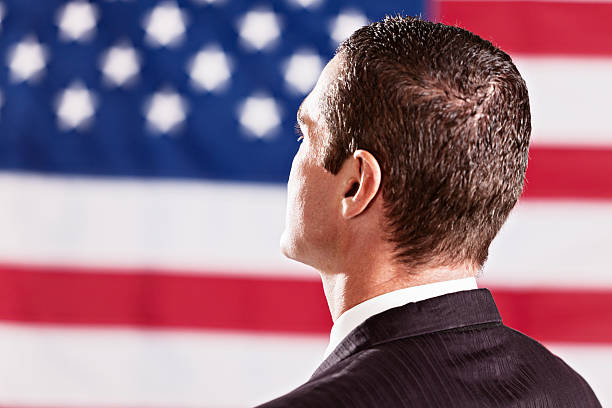 istock Rearview of man looking at US national flag 170034580