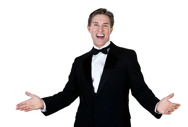 Waist up composition of a mature man with an excited expression wearing a tuxedo and isolated on white background 