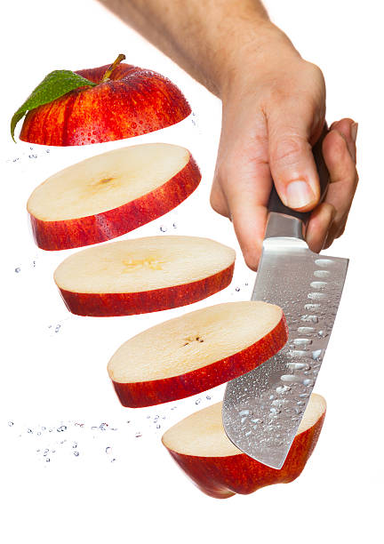 Slicing green smith apple in half. Directly above view. Photo is taken with dslr camera in studio.