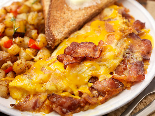 The Ultimate Bacon And Cheddar Cheese Omelette with Hash Brown Potatoes and Whole Wheat Toast - Photographed on Hasselblad H3D2-39mb Camera