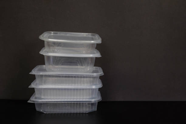 istock Five disposable transparent plastic containers of different sizes close-up on a black background 1700351952