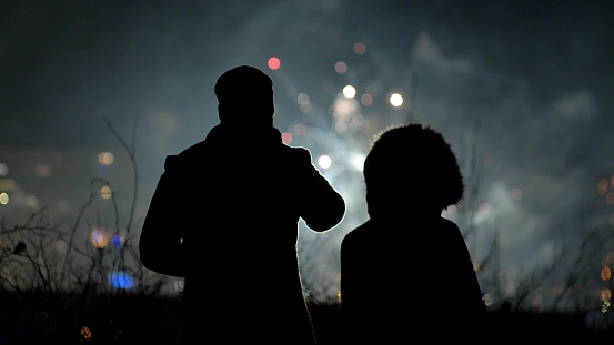 Romantic Couple Silhouettes Enjoying Fireworks New Years Eve Show Background