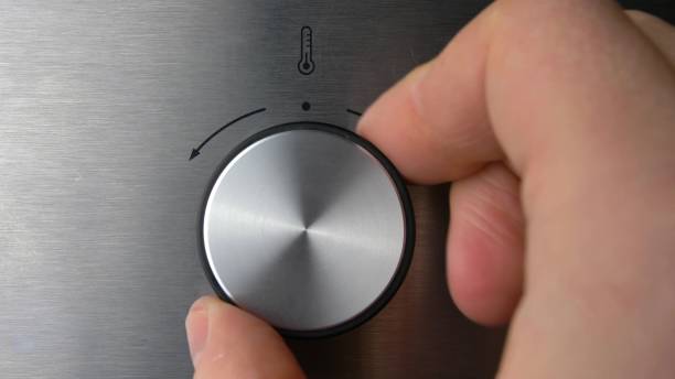 istock Adjusting Electric Oven Temperature by Turning the Oven Switch Close Up 1700355359
